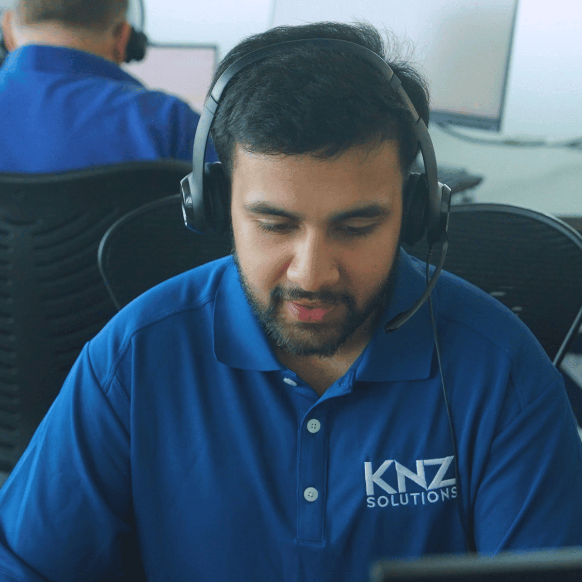 IT professional providing technical support at a computer